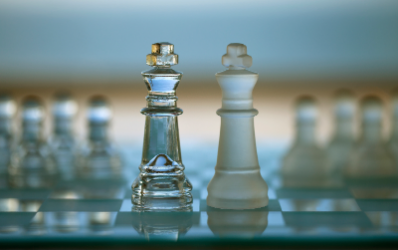 Clear glass chess pieces on a chess board