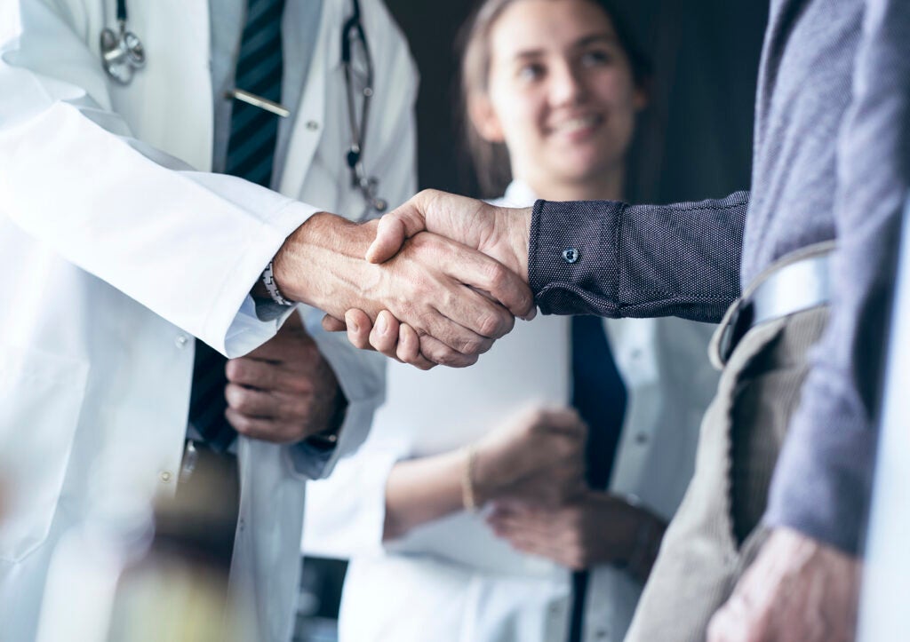 Doctor shaking hands with patient after providing value-based care